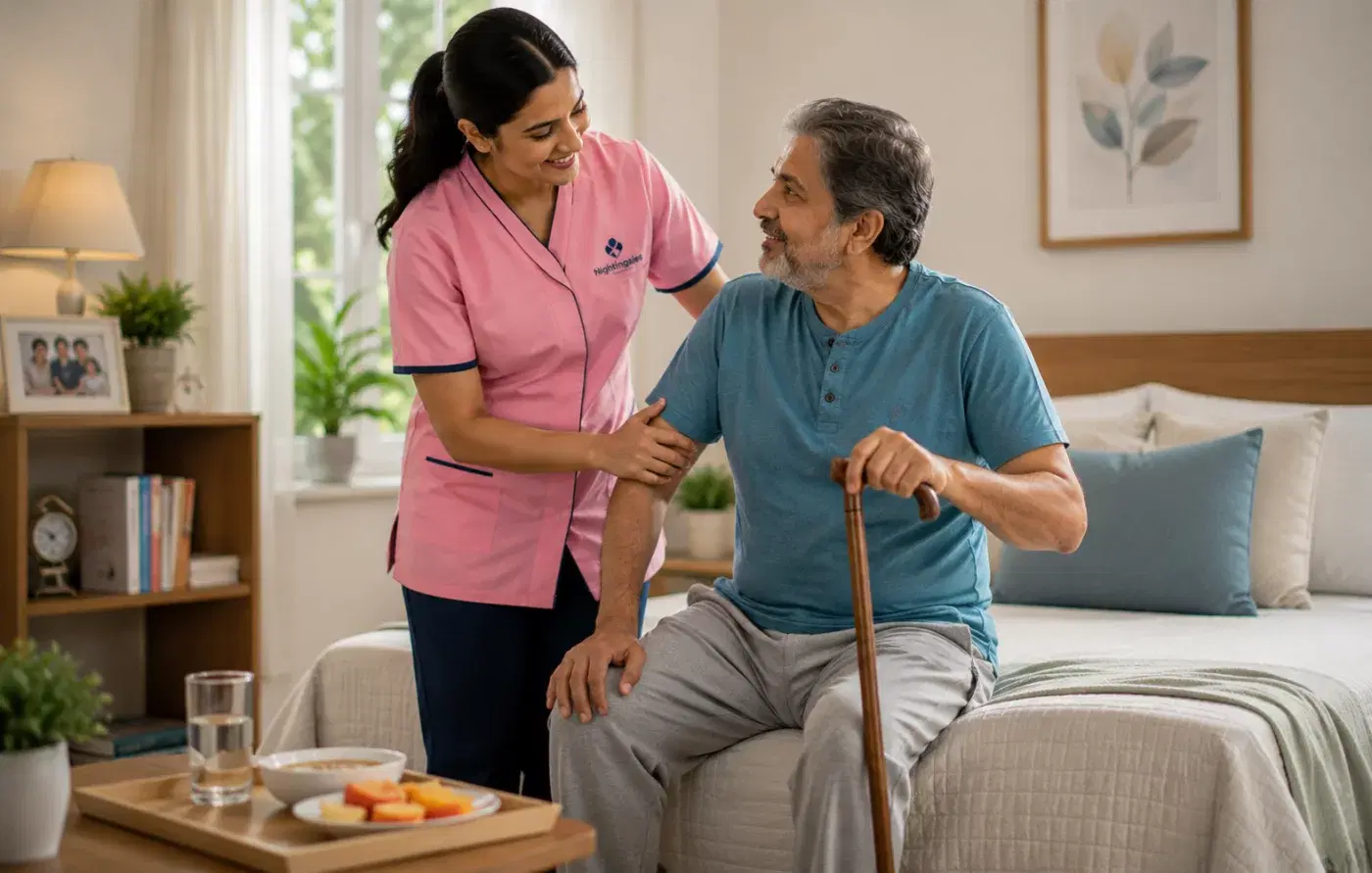 A caregiver helping an elderly man stand up with the support of a cane.